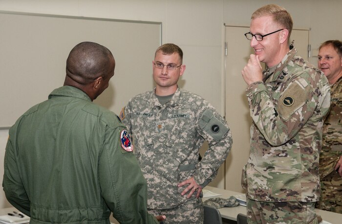 Army Lt. Col. Bryan C. Jones (right), commander, U.S. Army Aviation Battalion-Japan, and Army Maj. Nolan D. Roggenkamp (center), operations officer, USAABJ, discuss how to best coordinate aviation assets with their U.S. Air Force counterpart during the second Tachikawa Helicopter Conference conducted July 26, 2016, in Camp Tachikawa, Japan. Hosted by the JGSDF Eastern Army, the conference brought together representatives from the Japan Self-Defense Forces, United States military branches, and Japan’s civil aviation authorities to exchange information and develop policies to conduct helicopter operations during a major disaster. As the only rotary wing battalion stationed in Japan, USAABJ serves as U.S. Army Japan’s primary asset for aviation support. USAABJ’s close partnership with its Japanese aviation counterparts has produced a bilateral agreement for the battalion to assist in an emergency response operation or disaster relief mission if the Japanese government requests it. (U.S. Army photo by Sgt. John L. Carkeet IV, U.S. Army Japan)