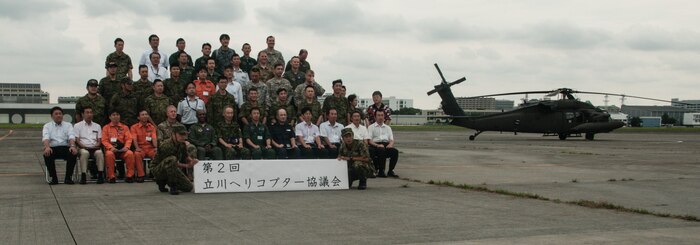 Senior leaders from approximately 20 military and civilian rotary wing organizations from Japan and United States pose for a group photo during the second Tachikawa Helicopter Conference conducted July 26, 2016, in Camp Tachikawa, Japan. Hosted by the JGSDF Eastern Army, the conference brought together representatives from the Japan Self-Defense Forces, United States military branches, and Japan’s civil aviation authorities to exchange information and develop policies to conduct helicopter operations during a major disaster. As the only rotary wing battalion stationed in Japan, U.S. Army Aviation Battalion-Japan serves as U.S. Army Japan’s primary asset for aviation support. USAABJ’s close partnership with its Japanese aviation counterparts has produced a bilateral agreement for the battalion to assist in an emergency response operation or disaster relief mission if the Japanese government requests it. (U.S. Army photo by Sgt. John L. Carkeet IV, U.S. Army Japan)