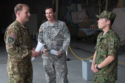 Army Chief Warrant Officer 3 Dan J. Blank, standardization pilot, U.S. Army Aviation Battalion-Japan, explains his command’s aviation assets and capabilities to his Japan Ground Self-Defense counterpart during the second Tachikawa Helicopter Conference conducted July 26, 2016, in Camp Tachikawa, Japan. Hosted by the JGSDF Eastern Army, the conference brought together representatives from the Japan Self-Defense Forces, United States military branches, and Japan’s civil aviation authorities to exchange information and develop policies to conduct helicopter operations during a major disaster. As the only rotary wing battalion stationed in Japan, USAABJ serves as U.S. Army Japan’s primary asset for aviation support. USAABJ’s close partnership with its Japanese aviation counterparts has produced a bilateral agreement for the battalion to assist in an emergency response operation or disaster relief mission if the Japanese government requests it.  (U.S. Army photo by Sgt. John L. Carkeet IV, U.S. Army Japan)