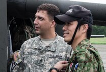 Army Staff Sgt. Joel Redman (left), crew chief, U.S. Army Aviation Battalion-Japan, gives a tour of one of his unit’s UH-60 Blackhawk helicopters to his Japan Ground Self-Defense Force counterpart during the second Tachikawa Helicopter Conference conducted July 26, 2016, in Camp Tachikawa, Japan. Hosted by the JGSDF Eastern Army, the conference brought together representatives from the Japan Self-Defense Forces, United States military branches, and Japan’s civil aviation authorities to exchange information and develop policies to conduct helicopter operations during a major disaster. As the only rotary wing battalion stationed in Japan, USAABJ serves as U.S. Army Japan’s primary asset for aviation support. USAABJ’s close partnership with its Japanese aviation counterparts has produced a bilateral agreement for the battalion to assist in an emergency response operation or disaster relief mission if the Japanese government requests it. (U.S. Army photo by Sgt. John L. Carkeet IV, U.S. Army Japan)