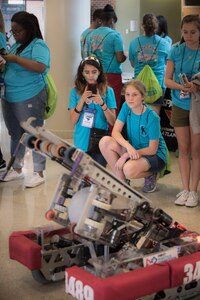 Girls Day Out participants watch a robot that is programmed to throw a ball July 29, 2016 at the College of Charleston. The event was sponsored by SPAWAR Systems Center Atlantic.
