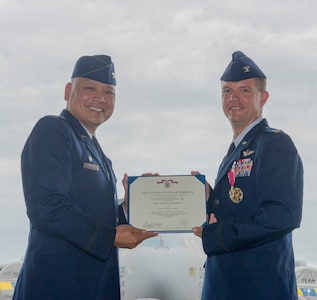 Col. Jimmy Canlas, 437th Airlift Wing (AW) commander, left, presents the Legion of Merit award to Col. Scovill Currin, former 437th Operations Group (OG) commander, during the 437th OG change of command ceremony in Nose Dock 2, Joint Base Charleston – AB, Charleston, SC, on Aug. 2, 2016. Currin’s next duty station is Seymour Johnson Air Force Base, NC where he will become the vice commander for the 916th Air Refueling Wing, Seymour Johnson Air Force Base, NC. (U.S. Air Force photo by Airman 1st Class Thomas T. Charlton)