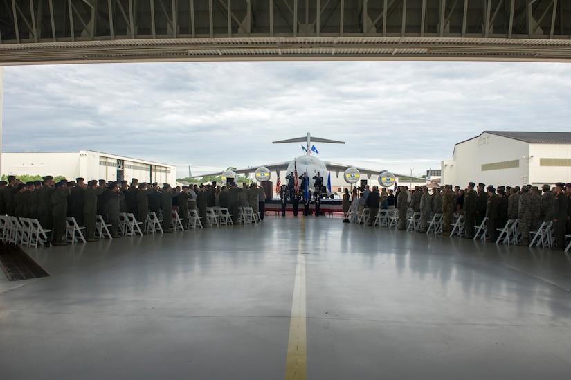 The 437th Operations Group (OG) salutes the presentation of the colors during the change of command ceremony held in Nose Dock 2, Joint Base Charleston – AB, Charleston, SC, Aug. 2, 2016. Former 437th OG commander, Col. Scovill Currin, stepped down, passing command to Col. Louis Hansen, new 437th OG commander. (U.S. Air Force photo by Airman 1st Class Thomas T. Charlton)