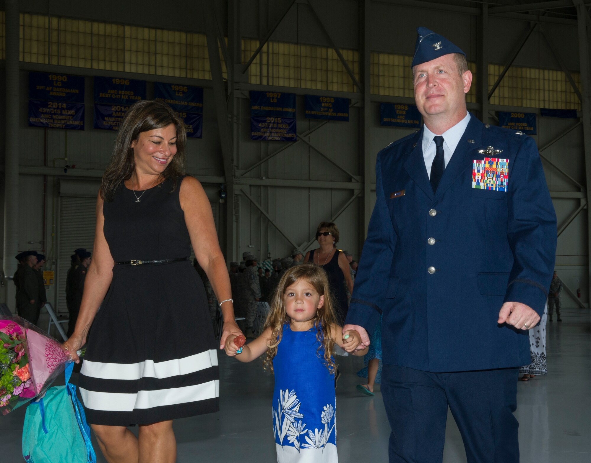 Col. Louis Hansen, right, 437th Operations Group (OG) commander, walks with his wife, Liz and their daughter, B’ella in Nose Dock 2, Joint Base Charleston – AB, Charleston, SC,  on Aug. 2, 2016. Hansen had just assumed command of the 437th OG. (U.S. Air Force photo by Airman 1st Class Thomas T. Charlton)