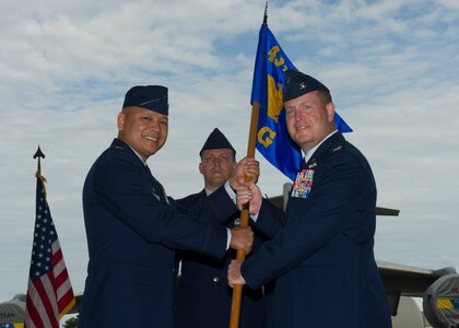 Col. Louis Hansen, 437th Operations Group (OG) commander, right, accepts the 437th OG guideon from Col. Jimmy Canlas, 437th Airlift Wing (AW) commander, during a change of command ceremony in Nose Dock 2, Joint Base Charleston – AB, Charleston, SC,  on Aug. 2, 2016. Hansen took over for former commander Col. Scovill Currin, 916th Aircraft Refueling Wing (ARW) vice commander - Seymour Johnson Air Force Base, NC. (U.S. Air Force photo by Airman 1st Class Thomas T. Charlton)