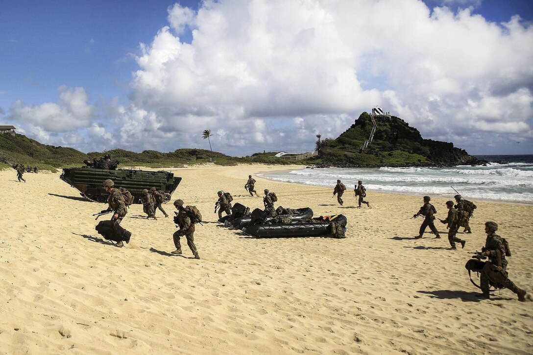 Marines assault a beach during Rim of the Pacific 2016, a maritime exercise in Hawaii, July 30, 2016. The Marines, assigned to Echo Company, Battalion Landing Team 2nd Battalion, 3rd Marine Regiment, launched from the USS San Diego. Marine Corps photo by Pfc. Sandra Garduno