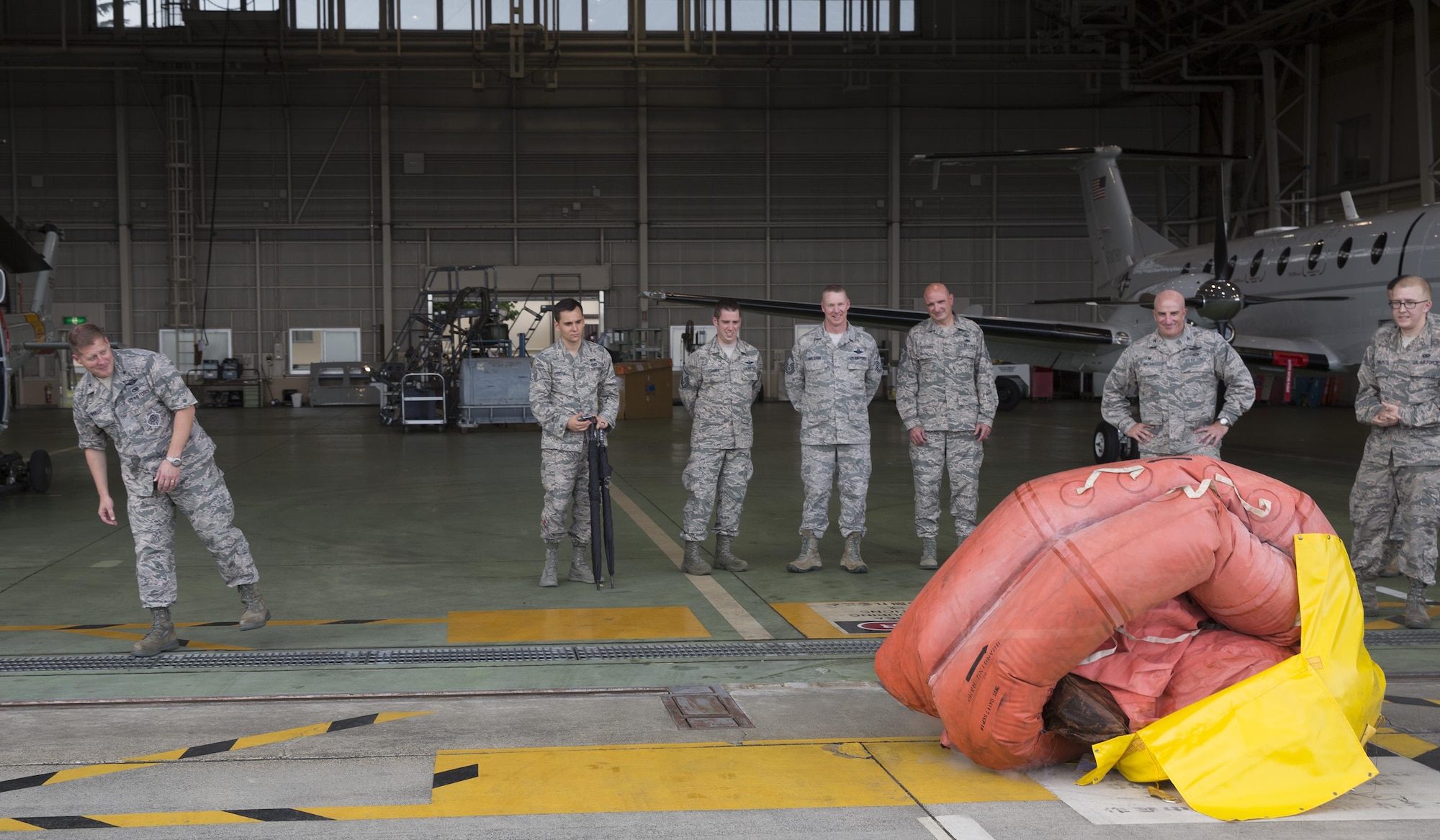 Brig. Gen. Michael Winkler, 5th Air Force vice commander, watches a F-2B life raft inflate during his immersion tour at Yokota Air Base, Japan, Aug. 2, 2016. Aircrew Flight Equipment specialists with the 374th Operations Support Squadron make sure aircrew have the supplies necessary for their missions. The team of AFE Airmen pack emergency items such as parachutes and survival kits and also maintain helmets and oxygen masks. (U.S. Air Force photo by Yasuo Osakabe/Released)  