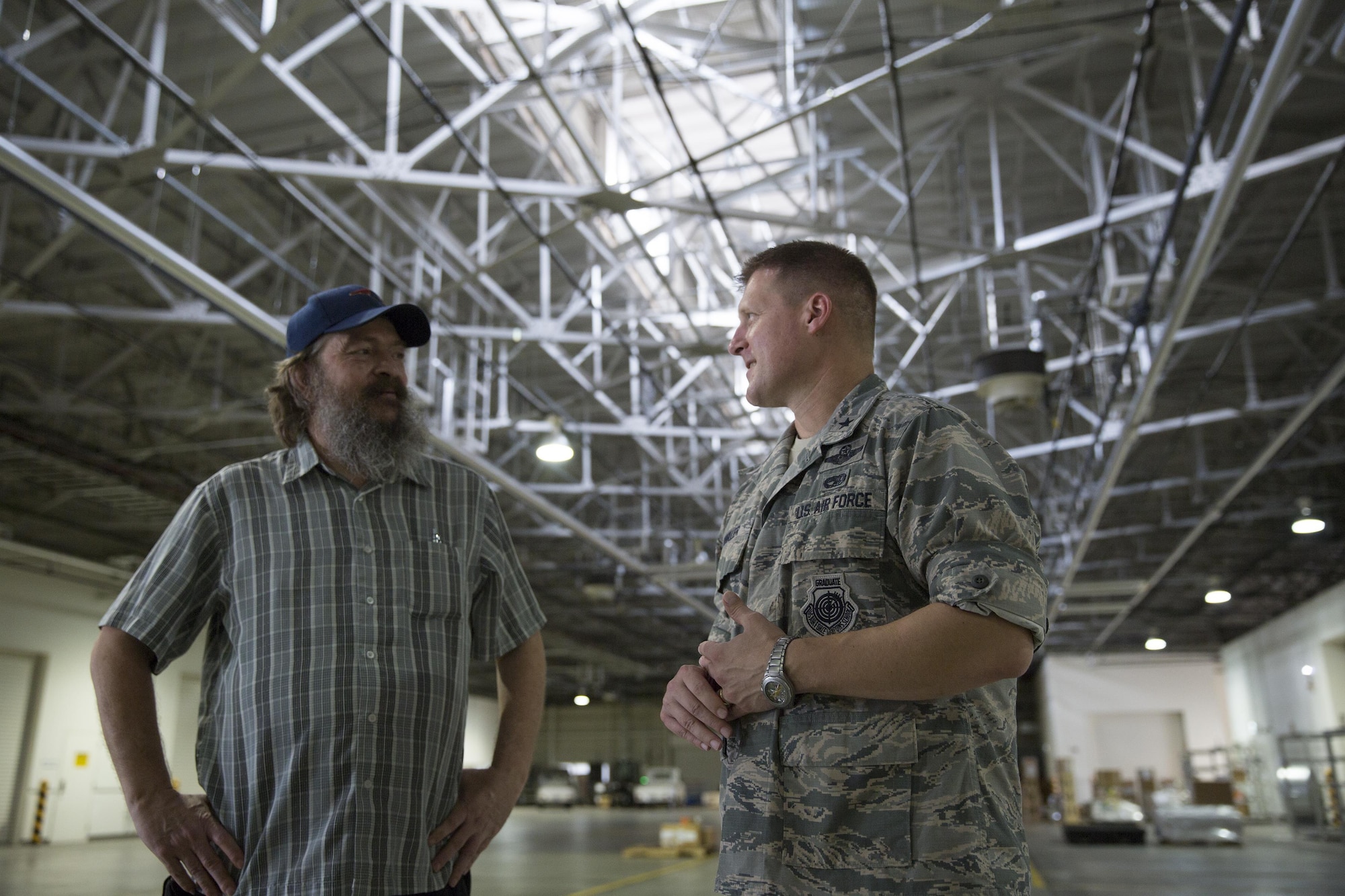 Brig. Gen. Michael Winkler, 5th Air Force vice commander, is briefed by Dean Labdon, 730th Air Mobility Squadron mechanized material handling system manager, on the MMHS capabilities at Yokota Air Base, Japan, Aug. 2, 2016, during his immersion tour. The automated system sorts, records and stores pallets in the warehouse based on their destination. (U.S. Air Force photo by Yasuo Osakabe/Released)