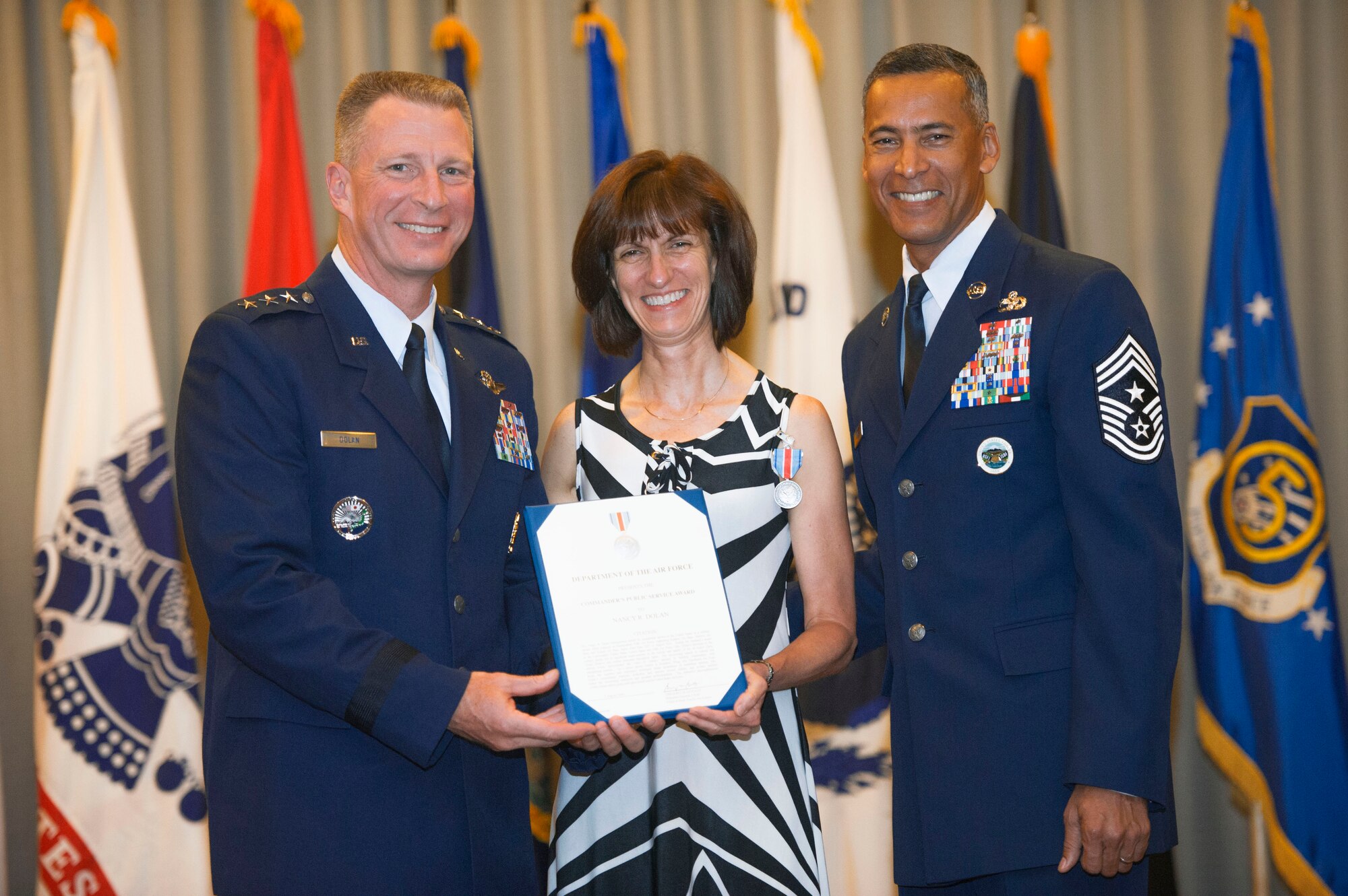Nancy Dolan, wife of former USFJ Commander Lt. Gen. John Dolan, receives the Commander's Public Service Award for her contributions toward improving morale and quality of life for military families throughout Japan,
Aug. 4, 2016. The award was presented at the ceremony marking General Dolan's relinquishment of command. (U.S. Air Force photo by Senior Airman Delano Scott/Released)
