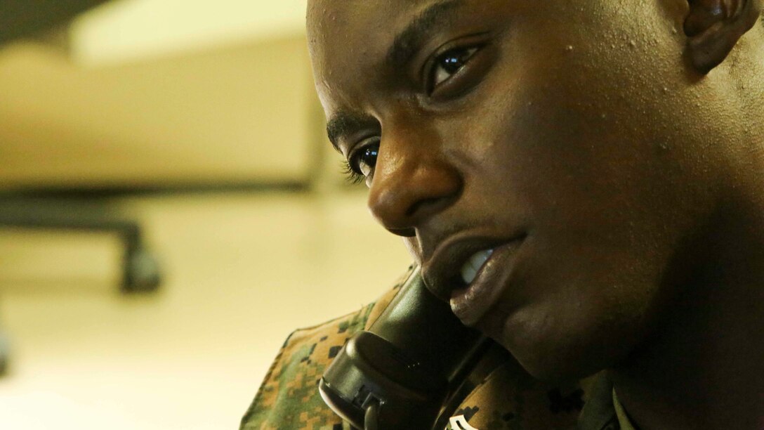 OKINAWA, JAPAN - Cpl. Imani Golden, an embarkation specialist with III Marine Expeditionary Force Headquarters Group, arranges flights for Marines Aug. 3, 2016. Embarkation specialists handle all logistics coordination when Marines travel to different countries. The forward nature of III MEF is crucial to readiness in the Pacific. Golden is from Brooklyn, New York. (U.S. Marine Corps photo by Lance Cpl. Nathaniel Cray/ Released)