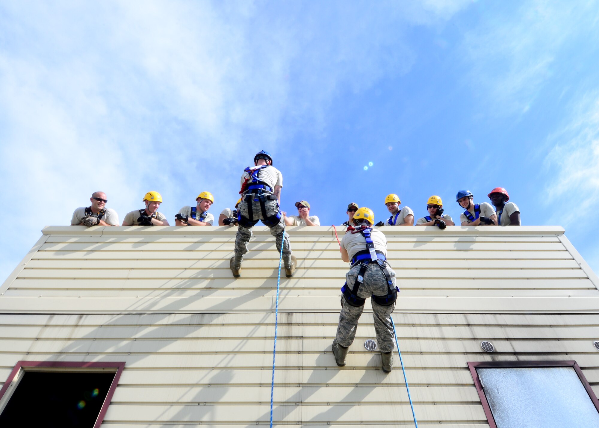 Firefighters from the 31st Civil Engineer Squadron rappel down a building during a Rescue Technician One course, Aug. 8, 2016, at Aviano Air Base, Italy. Fourteen Aviano firefighters are participating in the training to learn how to conduct low-angle, high-angle and confined-space rescues. (U.S. Air Force photo by Senior Airman Areca T. Bell/Released)