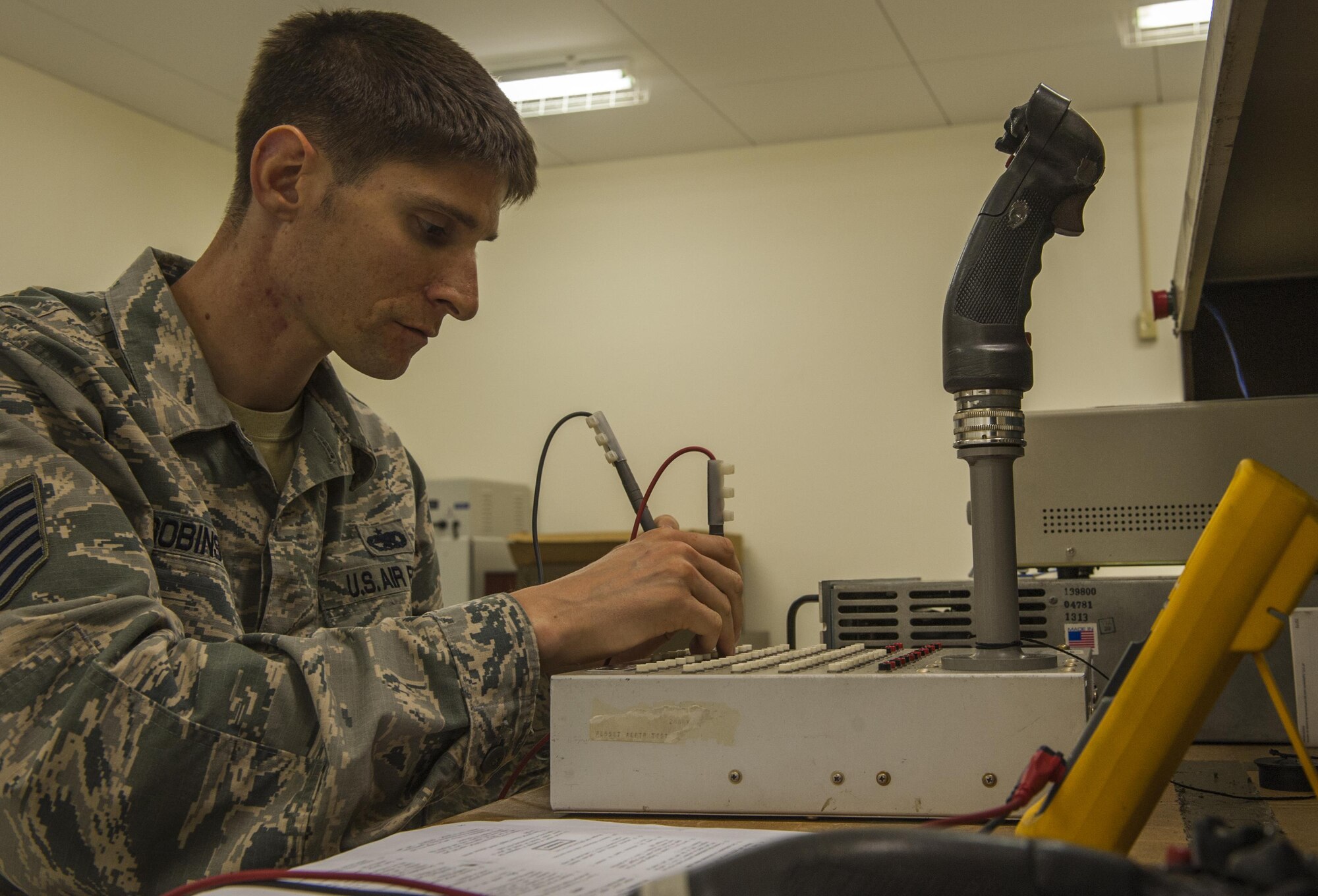 Tech. Sgt. Andrew Robinson, NCO in charge of the Air Force repair enhancement program, troubleshoots an F-15 flight stick inside the Air Force repair enhancement program shop Aug. 3, 2016, on Kadena Air Base, Okinawa, Japan. AFREP’s number one priority is positively impacting the flying mission by helping to return aircraft parts for further use. (U.S. Air Force Photo by Airman 1st Class Nick Emerick)

