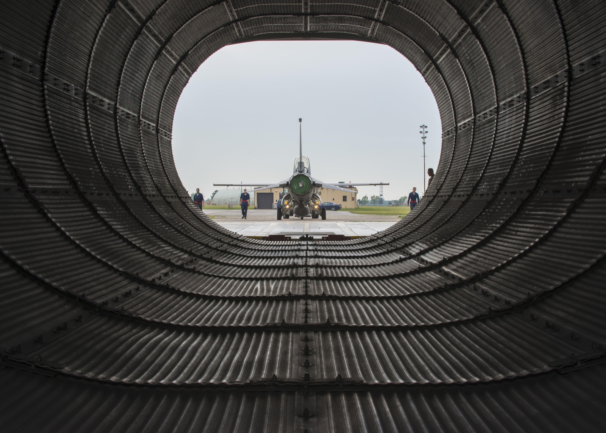 Phase crew chiefs from the 31st Maintenance Squadron guide an F-16 Fighting Falcon into the hush house July 28, 2016, at Aviano Air Base, Italy. A hush house is an enclosed structure made of noise suppression material that muffles the sounds produced by turbine engines. (U.S. Air Force photo by Airman 1st Class Cory W. Bush/Released)