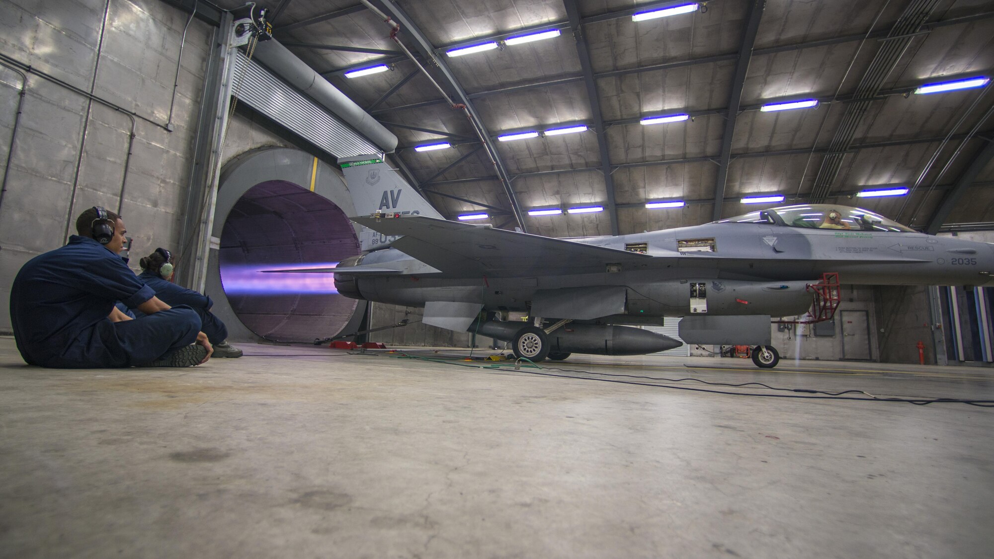 Staff Sgt. Johnathan Lewis and Airman 1st Class Taysialynn Genobaga-Arneho, 31st Maintenance Squadron phase crew chiefs, monitor an F-16 Fighting Falcon while running at full afterburner during a diagnostics test July 28, 2016, at Aviano Air Base, Italy. A hush house is an enclosed structure made of noise suppression material that muffles the sounds produced by turbine engines. (U.S. Air Force photo by Airman 1st Class Cory W. Bush/Released)