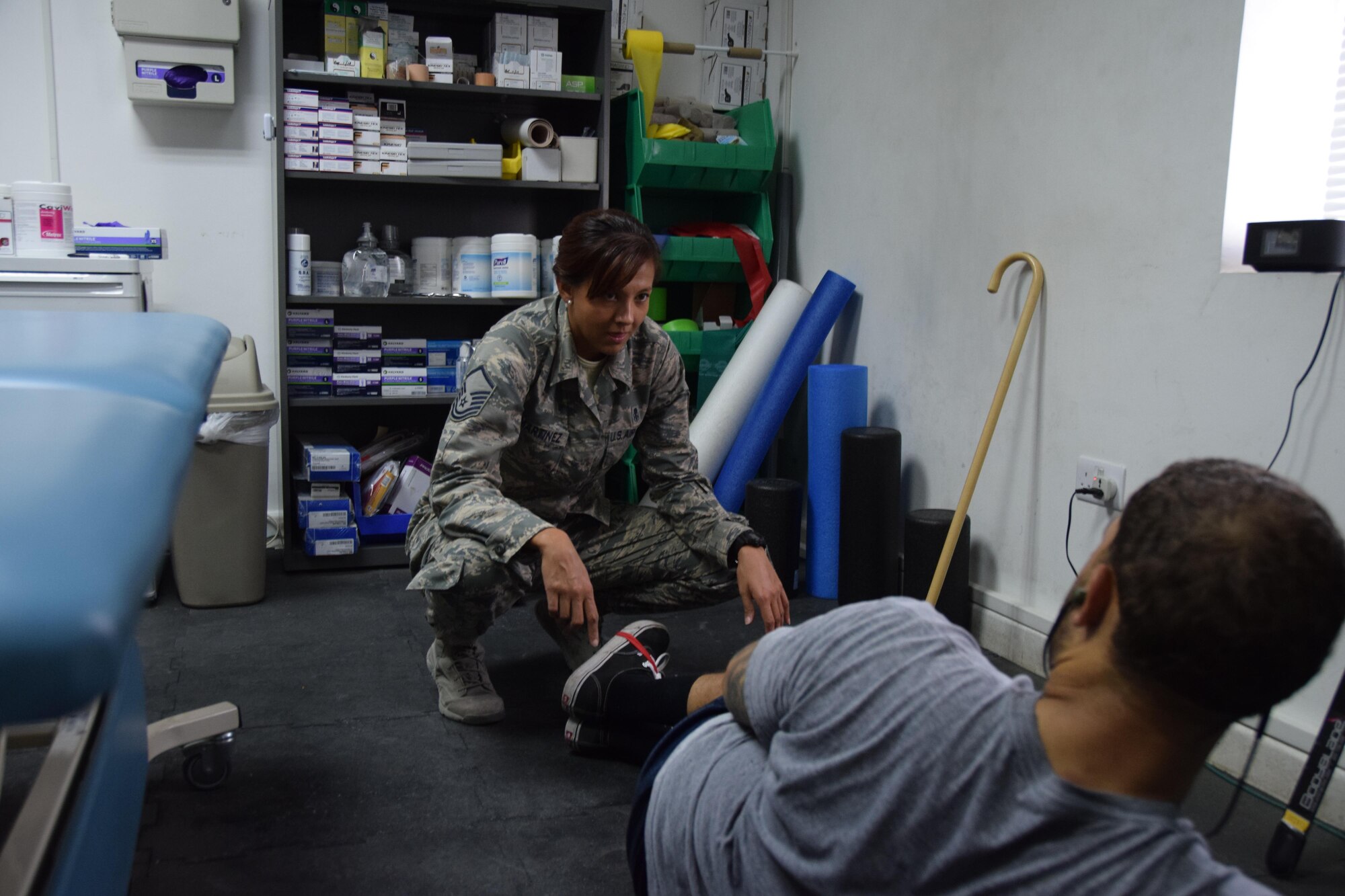 Master Sgt. Stephanie A. Martinez, 379th Expeditionary Medical Operations Squadron physical therapy assistant, works with U.S. Army Sgt. Karl Hawthorne, Combined Air Operations Center air defense communications and tactics specialist, on muscular strengthening exercises using stretch bands July 28, 2016, at Al Udeid Air Base, Qatar. The physical therapy clinic here sees approximately 300 patients a month, and while service members don't require a referral from their Primary Care provider before a visit, the condition should impact ones job performance before making an appointment. (U.S. Air Force photo/Technical Sgt. Carlos J. Treviño/Released)