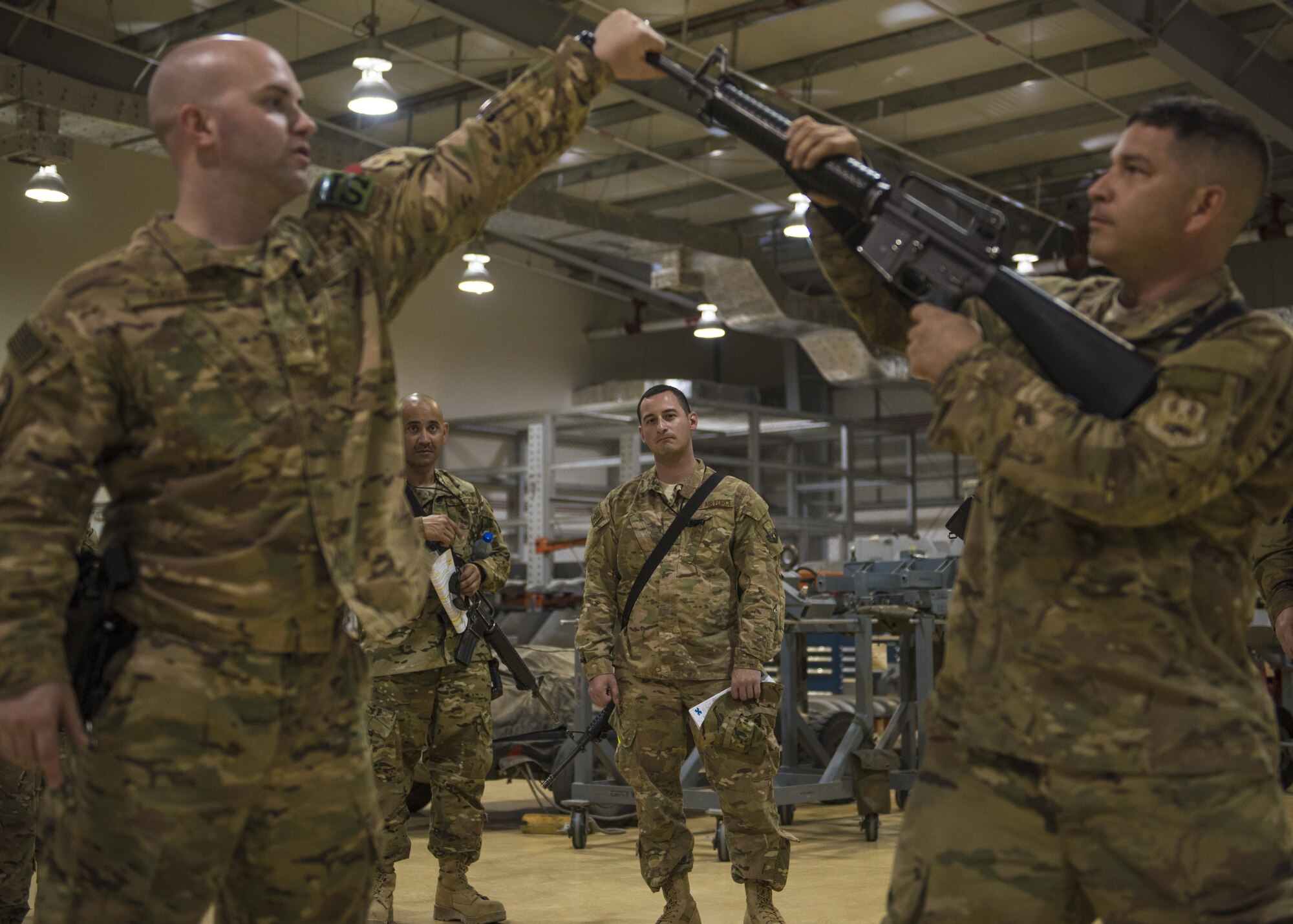 Tech. Sgt. John Havens, 455th Expeditionary Security Forces Squadron Check Six instructor and Staff Sgt. Rainier Soto, 455th Expeditionary Maintenance Squadron, demonstrates weapon drills, Bagram Airfield, Afghanistan, Aug. 02, 2016.  Check 6 teaches Airmen to be aware of their surroundings at all times, and most importantly how to defend themselves and others in the event a hostile threat occurs. (U.S. Air Force photo by Senior Airman Justyn M. Freeman)