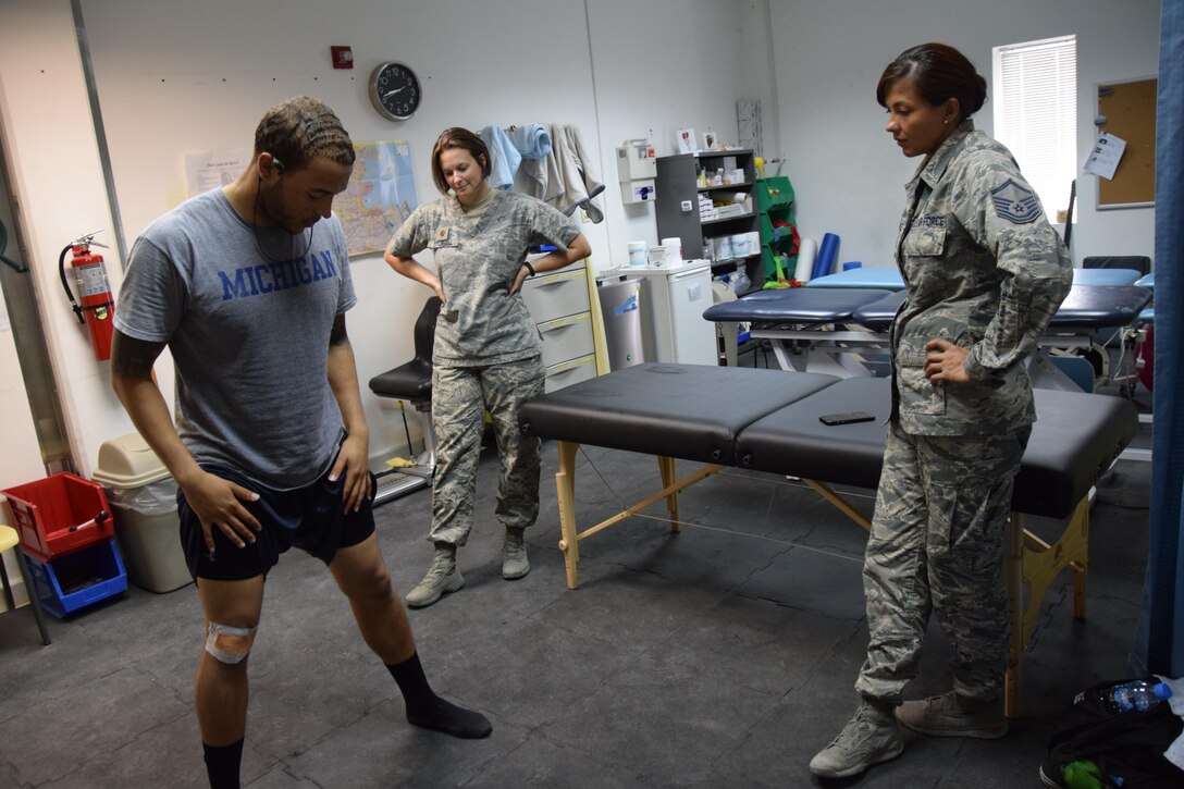 Maj. Erin R. Sturgell, 379th Expeditionary Medical Operations Squadron physical therapist, and Master Sgt. Stephanie A. Martinez, 379th EMDOS physical therapy assistant, works with U.S. Army Sgt. Karl Hawthorne, Combined Air Operations Center air defense communications and tactics specialist, on muscular strengthening exercises to strengthen the muscles above and below his knee July 28, 2016, at Al Udeid Air Base, Qatar. The clinic will begin offering classes for core stabilization, hip strengthening and mobility and flexibility once a month at the Blatchford-Preston Complex gym starting August 17. (U.S. Air Force photo/Technical Sgt. Carlos J. Treviño/Released)