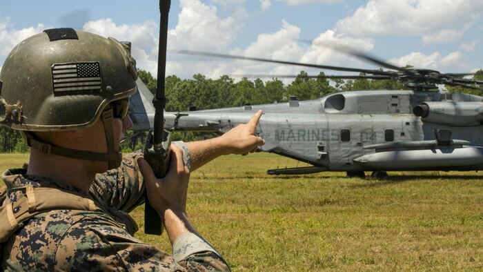 Cpl. Robert Blakeslee, an electric equipment repair specialist with 2nd Air Naval Gunfire Liaison Company, coordinates with the pilot of a CH-53E Super Stallion July 28, 2016 during a troop lift exercise at Marine Corps Air Station New River. The CH-53E Super Stallion is the largest helicopter in the United States military, and able to carry a 26,000-pound Light Armored Vehicle, 16 tons of cargo, or enough combat-loaded Marines to lead an assault or humanitarian operation. The capabilities provided by the CH-53E strengthen the expeditionary capabilities of Marines Corps units and make this aircraft one of the most useful in the Marine Corps. The CH-53E and pilot are assigned to Marine Heavy Helicopter Squadron 461, Marine Aircraft Group 29, 2nd Marine Aircraft Wing. ANGLICO is part of the II Marine Expeditionary Force Headquarters Group.