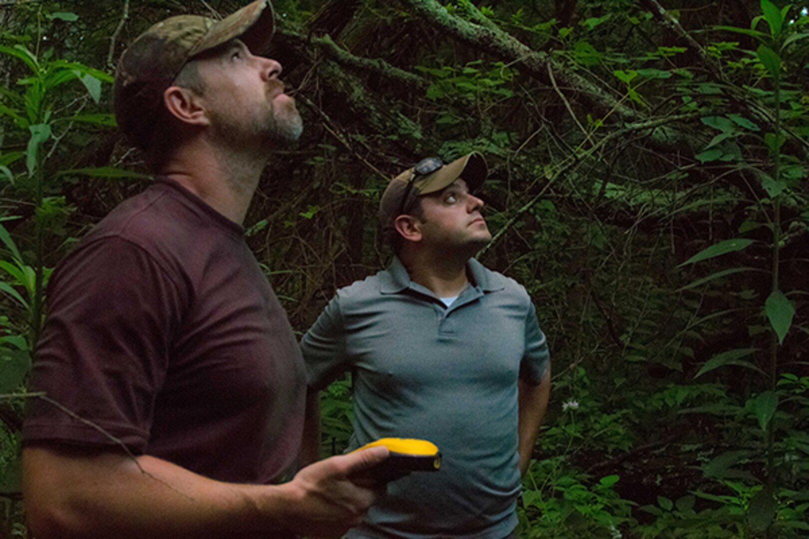 Mike Peterkin, deputy chief of conservation, right, and Todd Eubank, biologist for threatened and endangered species are tracking a bat roost at Camp Atterbury, Indiana, as part of the Acoustic Bat Training class held by the Environmental Management Office from July 11-16, 2016. The purpose of the class was to train the environmentalists on new methods of capturing ultrasonic bat calls that are used to recognize and identify the calls with the species they belong to. This information will further their understanding about the bat habitats, and how Camp Atterbury’s training affects their ecosystem. 
