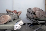 Soldiers with the 2nd Infantry Division rest on military cots during their deployment in support of Operation Iraqi Freedom in June 2010. DLA Troop Support's Construction and Equipment supply chain provides military cots for warfighters and for disaster relief operations, and sent 400 to Alaska for use during a training exercise this summer.