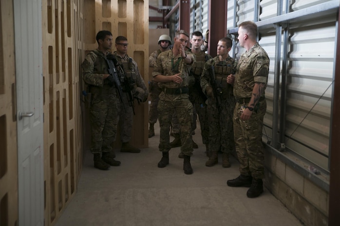 Close Quarters Battle instructors speak to U.S. Marines and sailors from the Marine Corps Security Force Regiment and Marine Corps Security Force Battalions Bangor and Kings Bay, and Royal Commandos from 43 Fleet Protection Group Royal Marines during Tartan Eagle 16 at the Northumbria Tactical Training Center, July 25, 2016. Tartan Eagle is an annual training package that began in 1994. The CQB portion  allowed the Marines and sailors to integrate with their British counterparts and exchange tactics while also learning new tactics.   (Official Marine Corps photo by Sgt. Calvin Shamoon/Released)