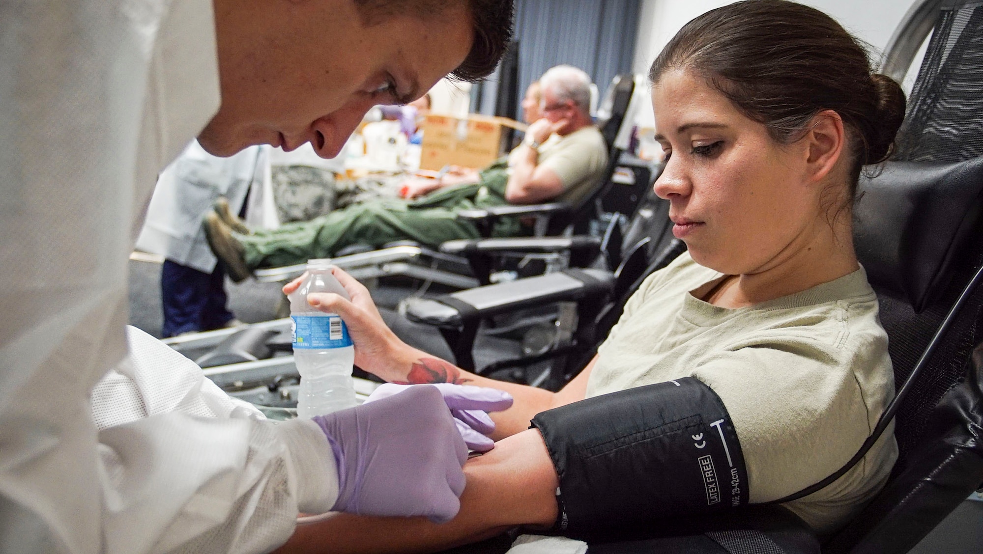 WRIGHT-PATTERSON AIR FORCE BASE, Ohio – Airman 1st Class Tyler Bennett, laboratory technician with the 88th Medical Group, prepares Tech. Sgt. Athena Yacoumakis, assistant non-commissioned officer in charge with the 445th Operations Support Squadron, to give blood during a blood drive event held at the 445th Aerospace Medicine Squadron auditorium July 16, 2016. Twelve Airmen donated blood which will go to a processing center in New Jersey to be sorted and sent overseas to aide American troops. The Wright Patt Blood Donor Center is in need mostly of O type blood because it can be given to any person in trauma situations regardless of their blood type. (U.S. Air Force photo/Staff Sgt. Devin Long)