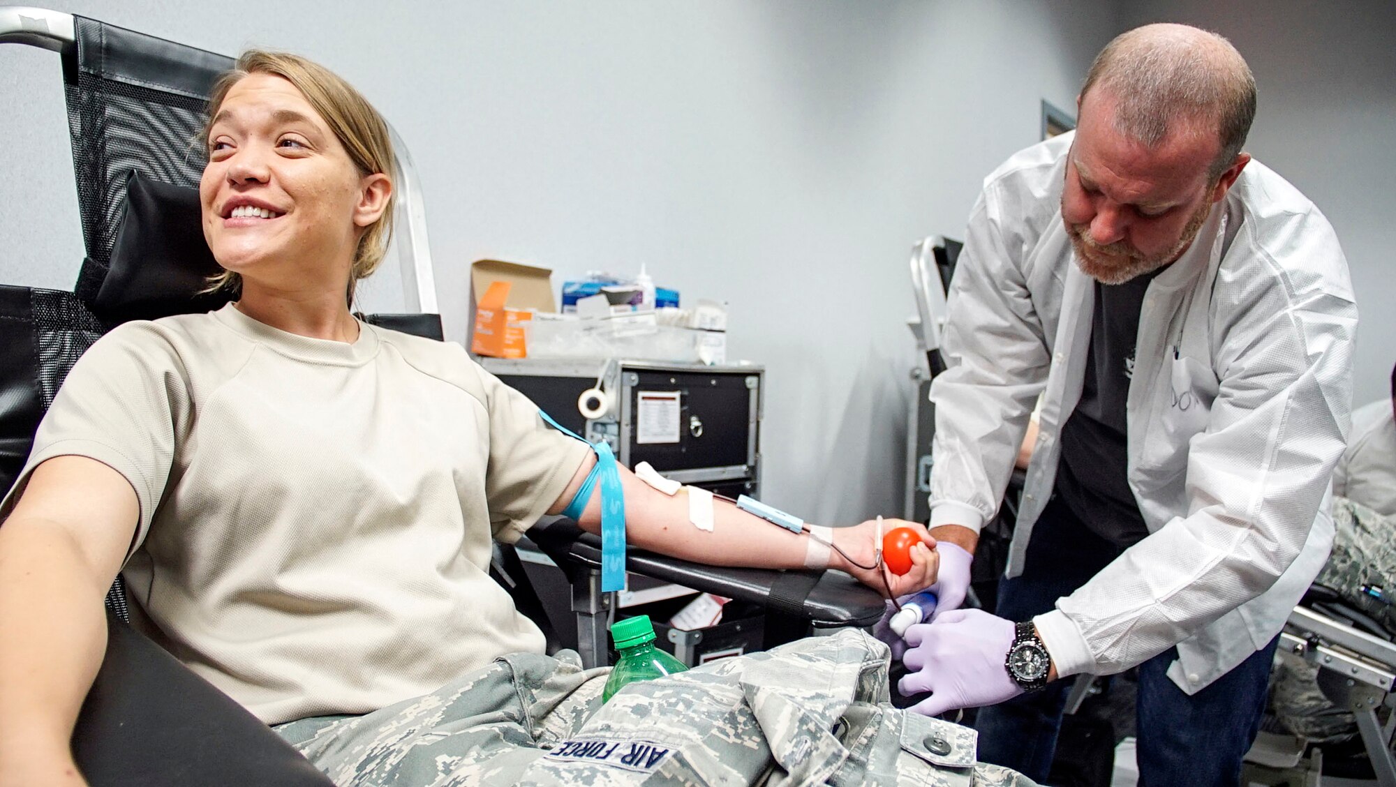 WRIGHT-PATTERSON AIR FORCE BASE, Ohio – Don Johnson, a medical laboratory technician with the 88th Medical Group Donor Center, takes blood from Senior Airman Amy Snavely, administrative technician with the 445th Aerospace Medicine Squadron, during a blood drive event at Wright-Patterson Air Force Base July 16, 2016. Twelve Airmen donated blood which will go to a processing center in New Jersey to be sorted and sent overseas to aide American troops. The Wright Patt Blood Donor Center is in need mostly of O type blood because it can be given to any person in trauma situations regardless of their blood type. (U.S. Air Force photo/Staff Sgt. Devin Long)