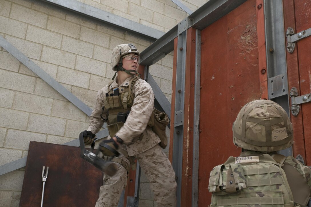 Cpl. Timothy Bishop, 5th Plt., Charlie Co., Fleet Anti-Terrorism Support Team, Marine Corps Security Force Regiment, applies breaching techniques during Tartan Eagle 16 Close-Quarters Battle training simulation at the Northumbria Tactical Training Center, in Northumbria, England, July 26, 2016. The CQB portion of Tartan Eagle allowed Marines and sailors to integrate with their British counterparts from 43 Fleet Protection Group Royal Marine and exchange tactics while also learning new tactics. The exercise allowed for the exchange of tactics, techniques and procedures in the security of strategic assets. (Official Marine Corps photo by Sgt. Calvin Shamoon/Released)
