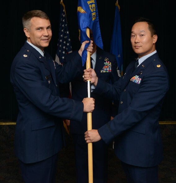 Maj. William Chang, right, 47th Contracting Flight commander, poses for a photo with Lt. Col. Dwayne Gray, 47th Mission Support Group deputy commander, during a change of command at Laughlin Air Force Base, Texas, July 19, 2016. Chang came to Laughlin from his previous position as the Chief of the Directorate of Contracting, Space and Missile Systems Center, Los Angeles Air Force Base, California. (U.S. Air Force photo/Airman 1st Class Brandon May)