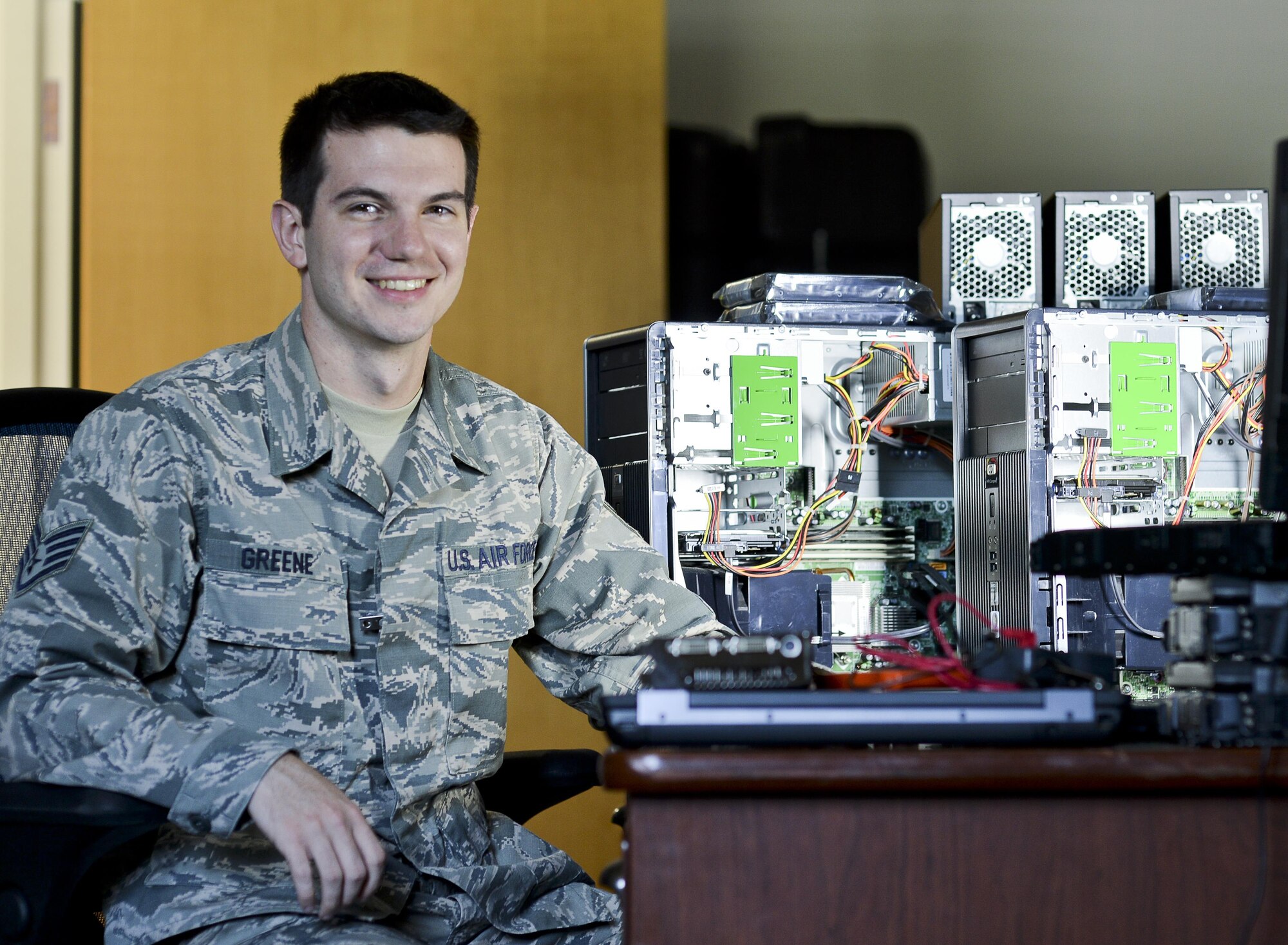U.S. Air Force Staff Sgt. Sam M. Greene, 325th Communications Squadron client systems supervisor, sits next to network computers at Tyndall Air Force Base, Fla., Aug. 3, 2016. Greene leads a small team of Airmen responsible for installing and maintaining computer hardware, software and a new base-wide voice over internet protocol phone service. (U.S. Air Force photo by Tech. Sgt. Javier Cruz Jr./Released)