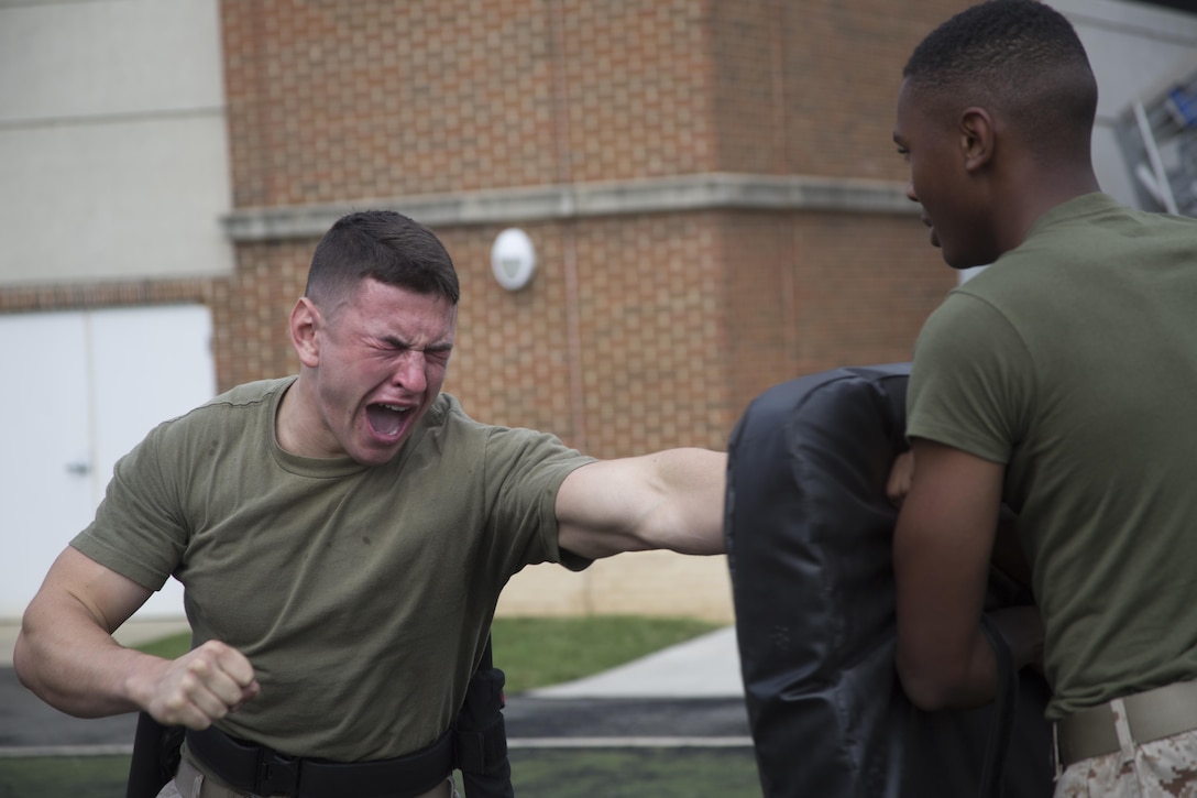 A Marine student from the Guard Academy conducts various striking techniques after being sprayed with oleoresin capsicum (OC) during training at the Annex Field, Marine Barracks Washington, D.C., Aug. 3, 2016. (Official Marine Corps photo by Cpl. Chi Nguyen/Released)