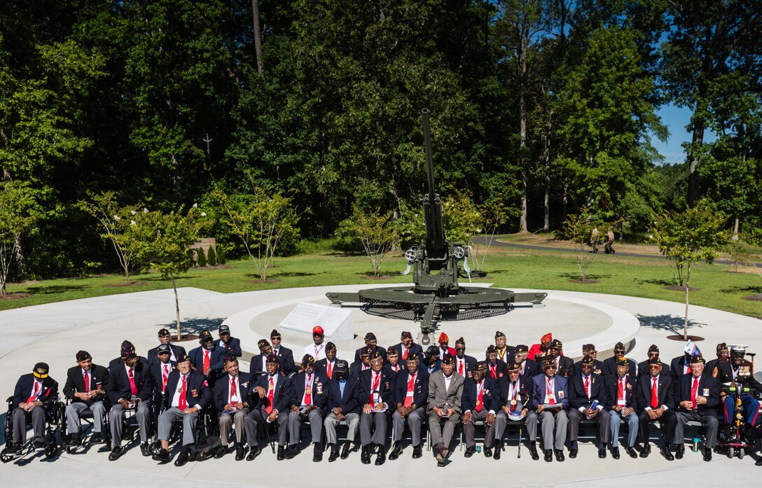 Montford Point Marines assemble for a group photo in front of the M1A1 anti-aircraft gun at the Montford Point Marine Memorial Dedication at Marine Corps Base Camp Lejeune July 29. Hundreds of attendees, including Montford Point Marines, family members, active duty servicemembers and supporters, gathered to attend the memorial dedication which honored the 20,000 segregated African-American Marines who trained there in the 1940s. (U.S. Marine Corps photo by Lance Cpl. Sean J. Berry/Released)