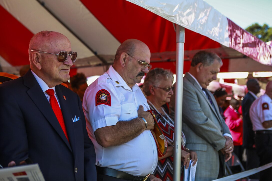 Members of the community listen to the invocation during the Montford Point Marine Memorial Dedication at Marine Corps Base Camp Lejeune July 29. Hundreds of attendees, including Montford Point Marines, family members, active duty servicemembers and supporters, gathered to attend the memorial dedication which honored the 20,000 segregated African-American Marines who trained there in the 1940s. (U.S. Marine Corps photo by Lance Cpl. Sean J. Berry/Released)