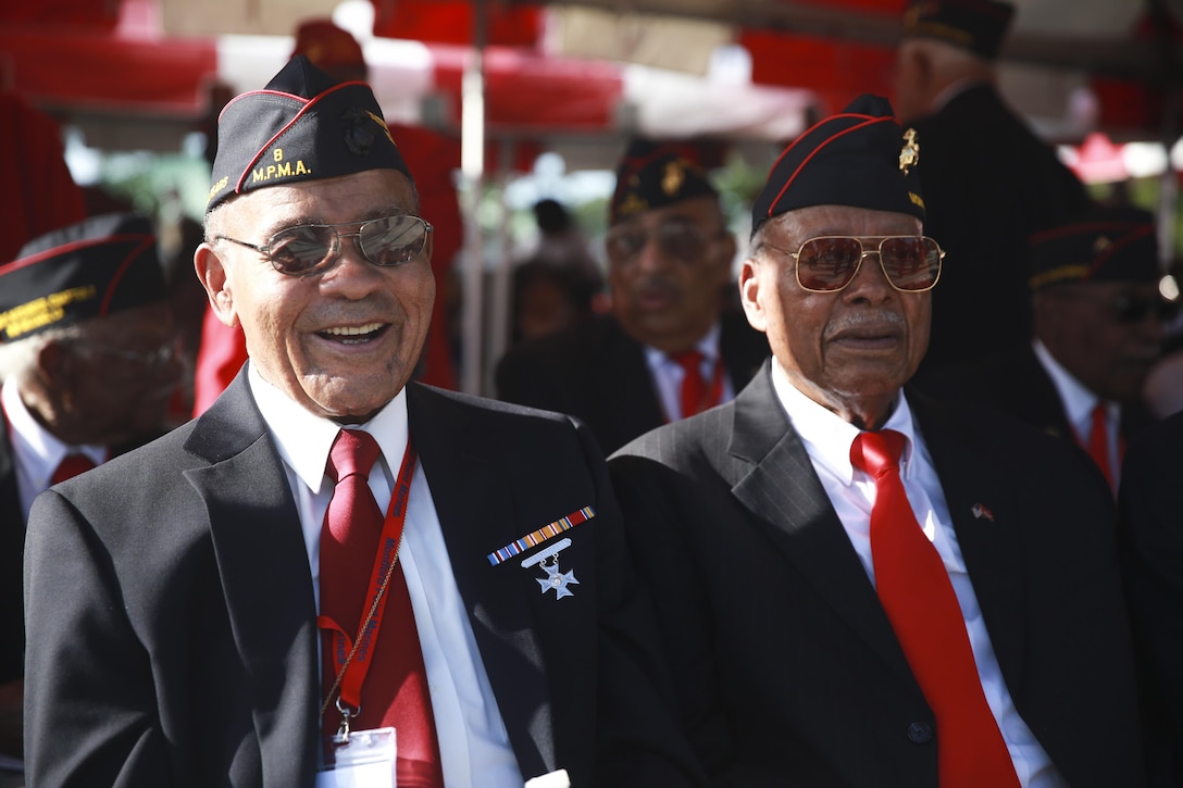 Two Montford Point Marines share memories during the Montford Point Marine Memorial Dedication at Marine Corps Base Camp Lejeune July 29. Hundreds of attendees, including Montford Point Marines, family members, active duty servicemembers and supporters, gathered to attend the memorial dedication which honored the 20,000 segregated African-American Marines who trained there in the 1940s. (U.S. Marine Corps photo by Lance Cpl. Sean J. Berry/Released)