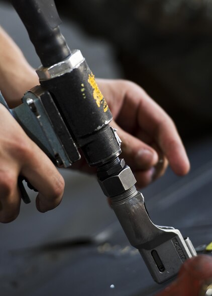 Airman 1st Class Anthony Walters, 5th Maintenance Squadron aircraft structural maintenance, prepares to fasten a spoiler patch atop the wing of a B-52H Stratofortress at Minot Air Force Base, N.D., August 2, 2016. The yellow sheet metal patches are riveted down to repair cracked spoilers on the B-52s. (U.S. Air Force photo/Airman 1st Class J.T. Armstrong)