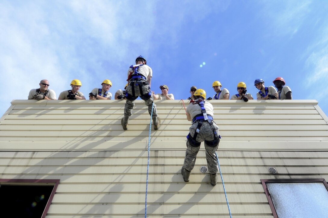 Air Force firefighters rappel down a building during a rescue course at Aviano Air Base, Italy, Aug. 2, 2016. Fourteen Aviano firefighters participated in the training to learn how to conduct rescues from low angles, high angles and confined spaces. Air Force photo by Senior Airman Areca T. Bell

