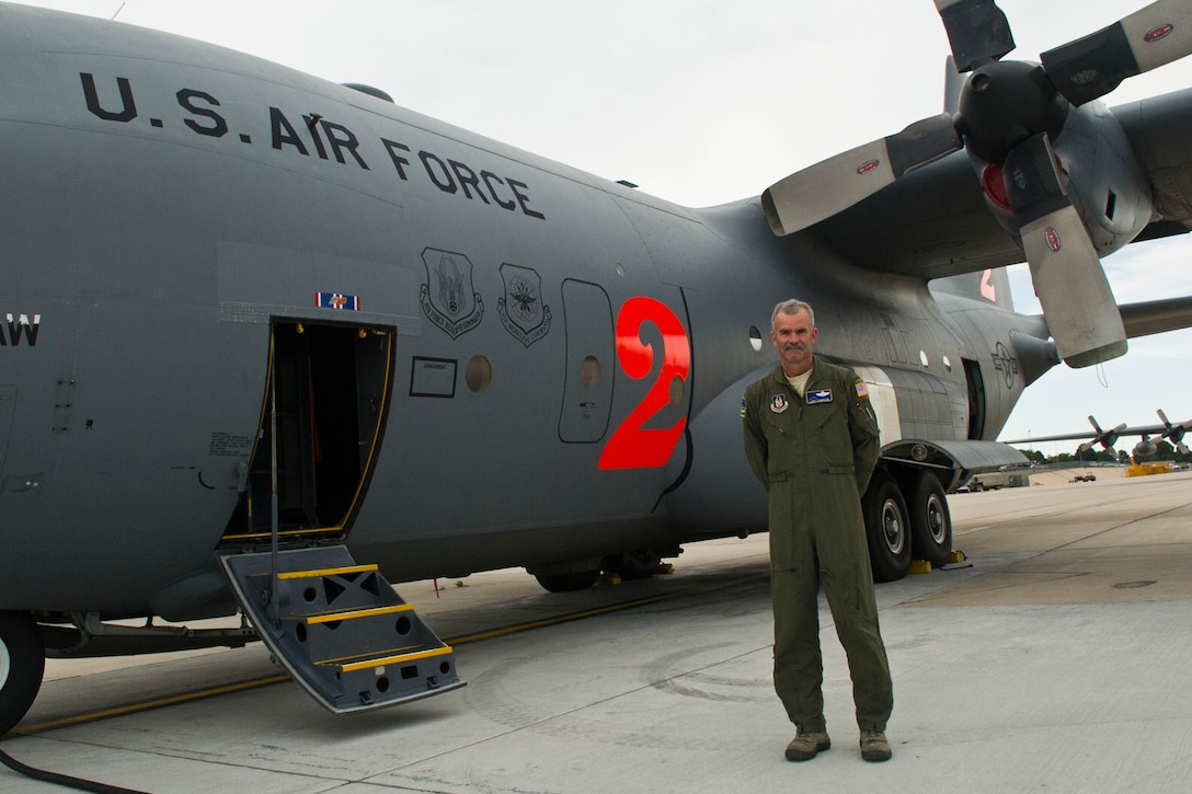 Air Force Lt. Col. Luke Thompson, with the Air Force Reserve Command's 302nd Airlift Wing, stands in front of a C-130 Hercules aircraft at Peterson Air Force Base, Colo., which is equipped with a Modular Airborne Fire Fighting System, July 26, 2016. DoD photo by Lisa Ferdinando