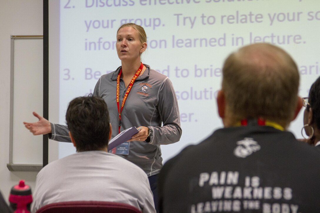 As part of a practical application, Becca Saal practices different briefing techniques with her fellow coaches during the 2016 Coaches Workshop at Marine Corps University aboard Marine Corps Base Quantico, Va., Aug. 4. The workshop creates a mutually beneficial relationship between coaches and the Marine Corps, where coaches can share knowledge about the Corps based on firsthand experience. Saal is the head volleyball coach for Carroll University in Waukesha, Wis. 