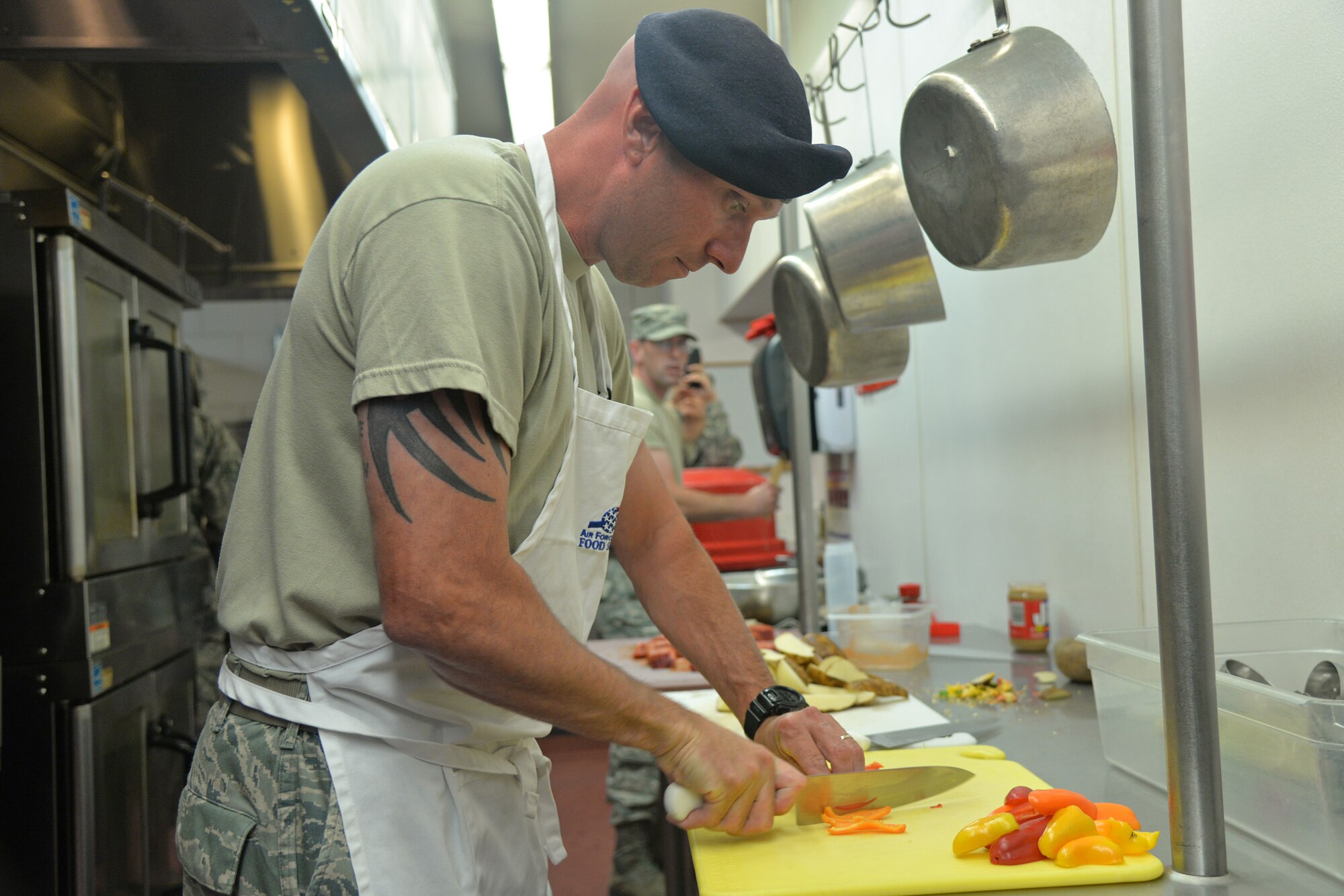 Master Sgt. James Nephew, 341st Security Forces Support Squadron training and logistics superintendent, slices peppers during the Warrior Chef competition Aug. 3, 2016, at Malmstrom Air Force Base, Mont. Each team had to prepare an entrée, side dish and dessert within one hour. (U.S. Air Force photo/Airman 1st Class Daniel Brosam)