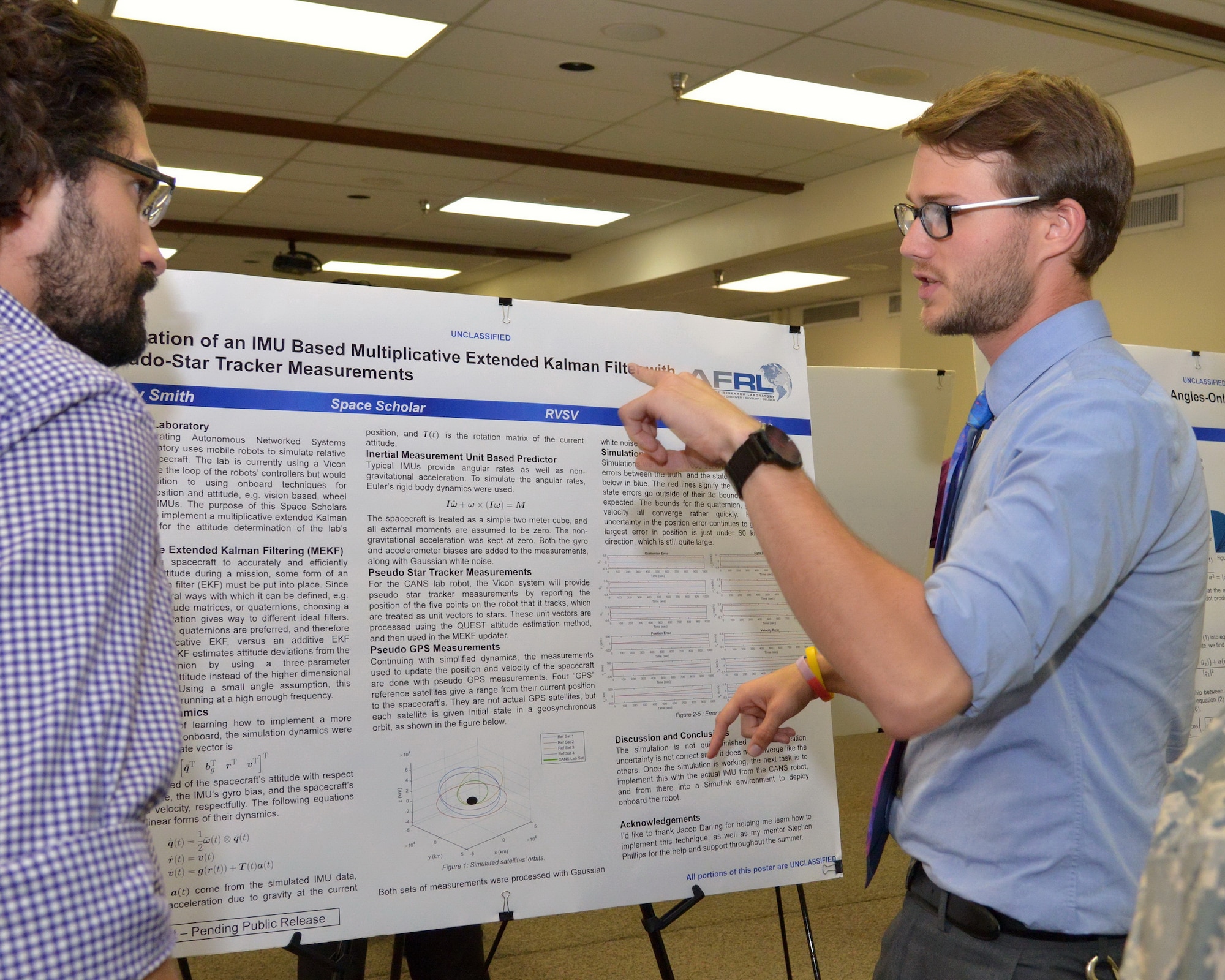 Casey Smith presents his research at the Air Force Research Laboratory Scholars Program Poster Session and answered questions from audience members. Summer interns work on a research project and present their findings at the poster session. (Photo by Jamie Burnett)