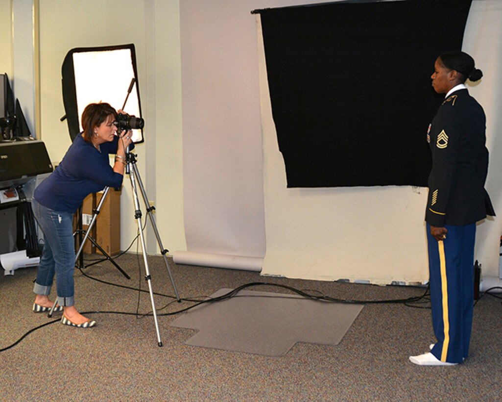 Jackie Roberts, Defense Logistics Agency, offical photographer, takes a Department of the Army Photo for an Army sergeant first class. Photographing military members for their offical photos for promotion selection, head and shoulder photos for command and leadership members are some of the services offered by the Customer Support Division photography and graphics shop. Roberts also provides photography support for ceremonies and events on the installation. 