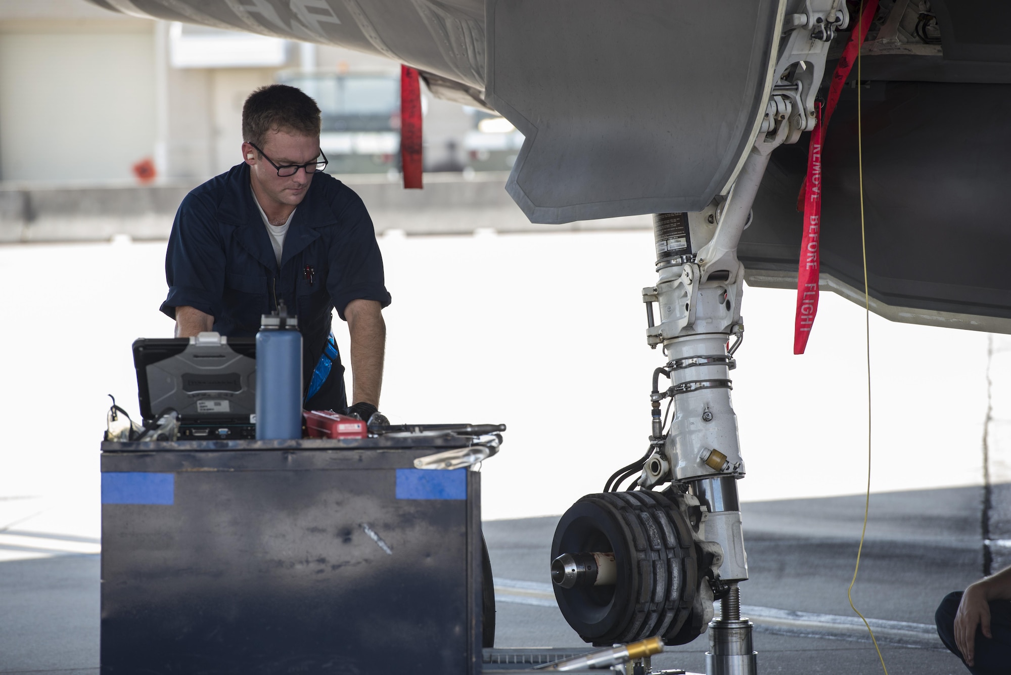 Staff Sgt. Joshua Davlin, 58th Aircraft Maintenance Unit crew chief, services an F-35A wheel Aug. 2, 2016, at Eglin Air Force Base, Fla. During the Aug. 1-3 sortie surge 58th AMU Airmen kept up with the high-tempo demand to provide safe and reliable aircraft for 111 sorties. (U.S. Air Force photo by Senior Airman Stormy Archer)