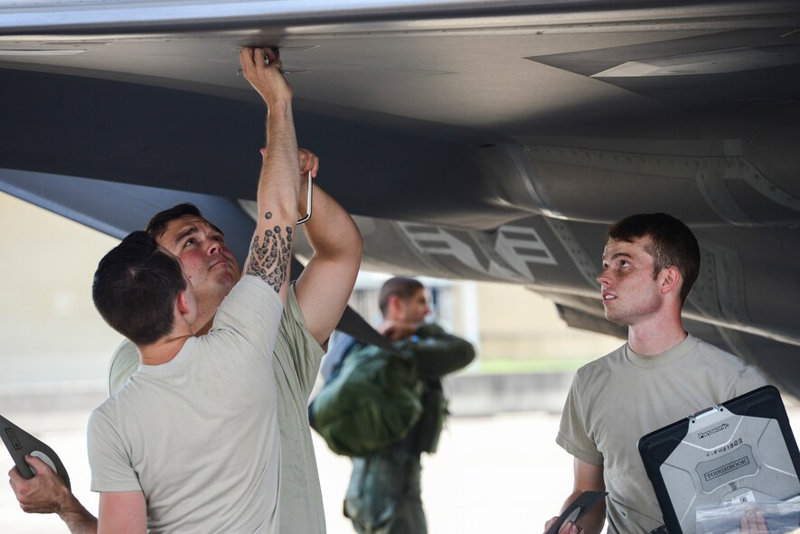 Airmen from the 58th Aircraft Maintenance Unit install a lower wing pylon cover panel on an F-35A Aug. 2, 2016, at Eglin Air Force, Fla. During the Aug. 1-3 sortie surge 58th AMU Airmen kept up with the high-tempo demand to provide safe and reliable aircraft for 111 sorties. (U.S. Air Force photo by Senior Airman Stormy Archer)