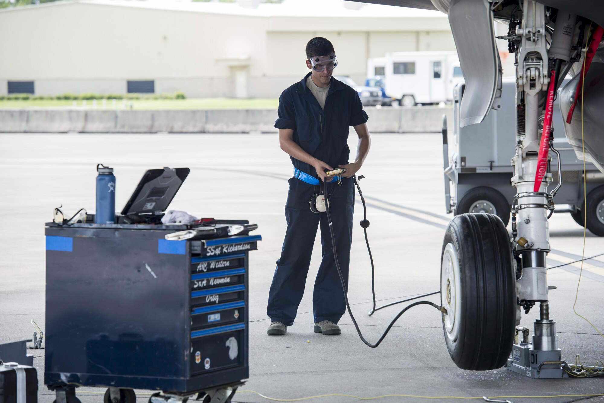 Airman Travis Boyle, 33rd Aircraft Maintenance Unit crew chief, services an F-35A wheel Aug. 2, 2016, at Eglin Air Force Base, Fla. During the Aug. 1-3 sortie surge 58th AMU Airmen kept up with the high-tempo demand to provide safe and reliable aircraft for 111 sorties. (U.S. Air Force photo by Senior Airman Stormy Archer)