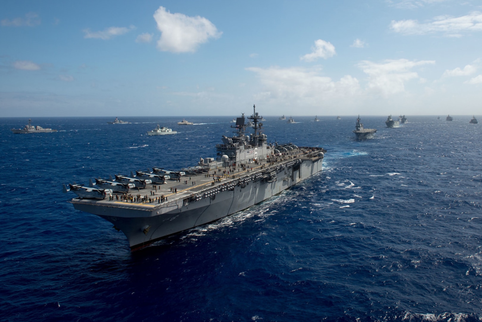 The amphibious assault ship USS America (LHA 6), one of 40 ships and submarines representing 12 international partner nations, steams along during a group sail as part of exercise Rim of the Pacific 2016. Twenty-six nations, more than 40 ships and submarines, more than 200 aircraft, and 25,000 personnel are participating in RIMPAC from June 30 to Aug. 4, in and around the Hawaiian Islands and Southern California. The world's largest international maritime exercise, RIMPAC provides a unique training opportunity that helps participants foster and sustain the cooperative relationships that are critical to ensuring the safety of sea lanes and security on the world's oceans. RIMPAC 2016 is the 25th exercise in the series that began in 1971. 