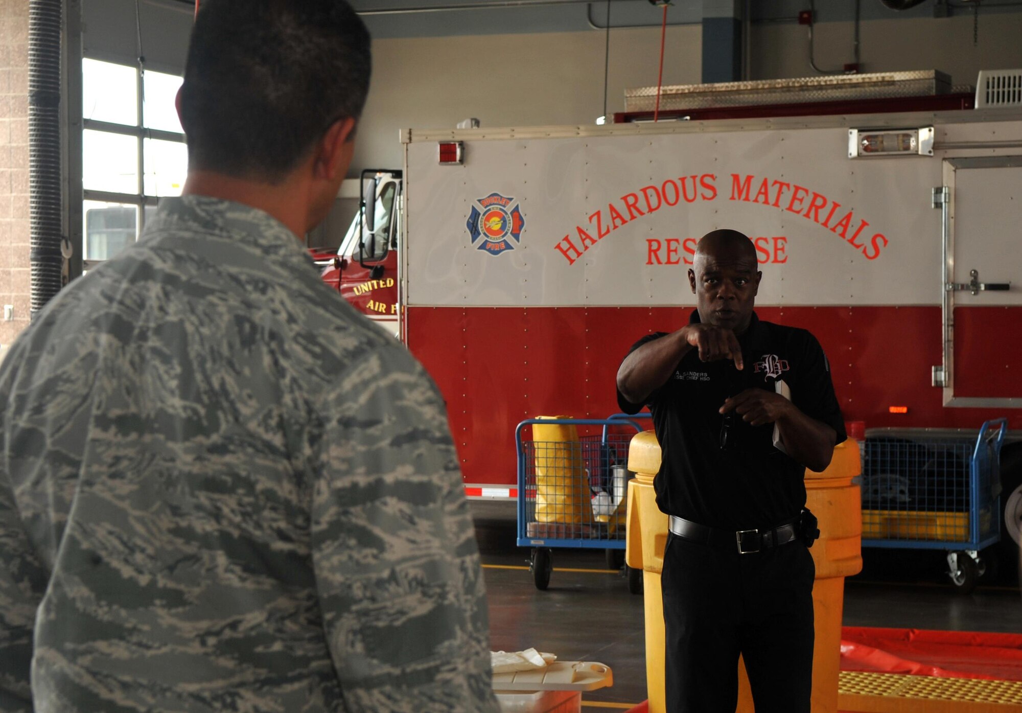 Buckley Fire Department members demonstrate the process and importance of responding to hazardous material incidents Aug. 2, 2016 on Buckley Air Force Base, Colo. The Emergency Operations Center Director Course students were briefed on how damaging different hazardous materials can become if not addressed safely and appropriately. (U.S. Air Force photo by Airman Holden S. Faul/ Released)