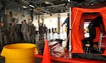 Buckley Fire Department members demonstrate the process and importance of responding to hazardous material incidents Aug. 2, 2016 on Buckley Air Force Base, Colo. The Emergency Operations Center Director Course students were briefed on how damaging different hazardous materials can become if not addressed safely and appropriately. (U.S. Air Force photo by Airman Holden S. Faul/ Released)