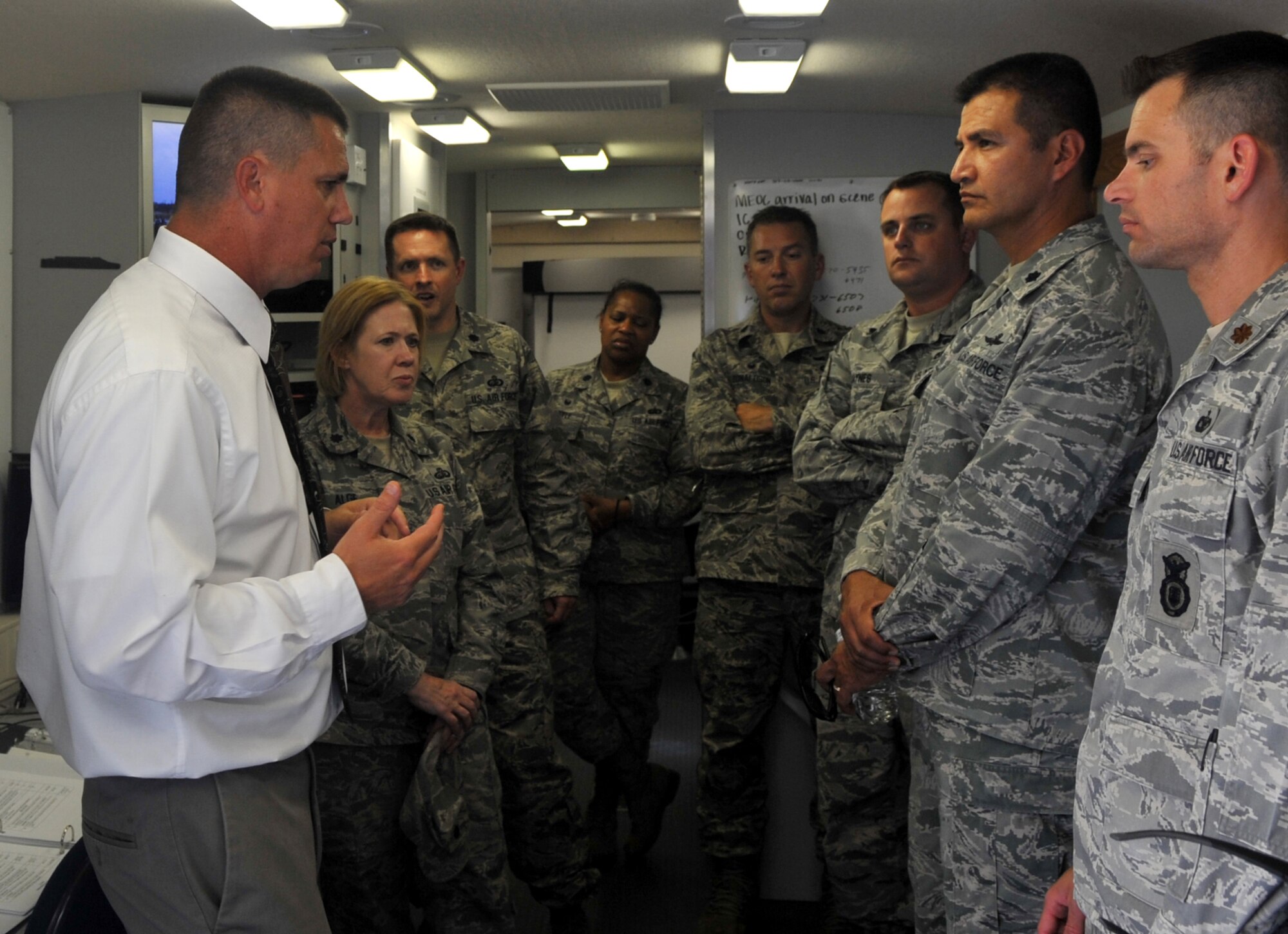 Eric A. Mueller, 460th Civil Engineer Squadron emergency manager, demonstrates the capabilities of Buckley's Mobile Emergency Operations Center to students of the EOC Director Course Aug. 2, 2016 at Buckley Air Force Base, Colo. Buckley's Mobile EOC makes operations easily conductible during any emergency depite location. (U.S. Air Force photo by Airman Holden S. Faul/ Released)