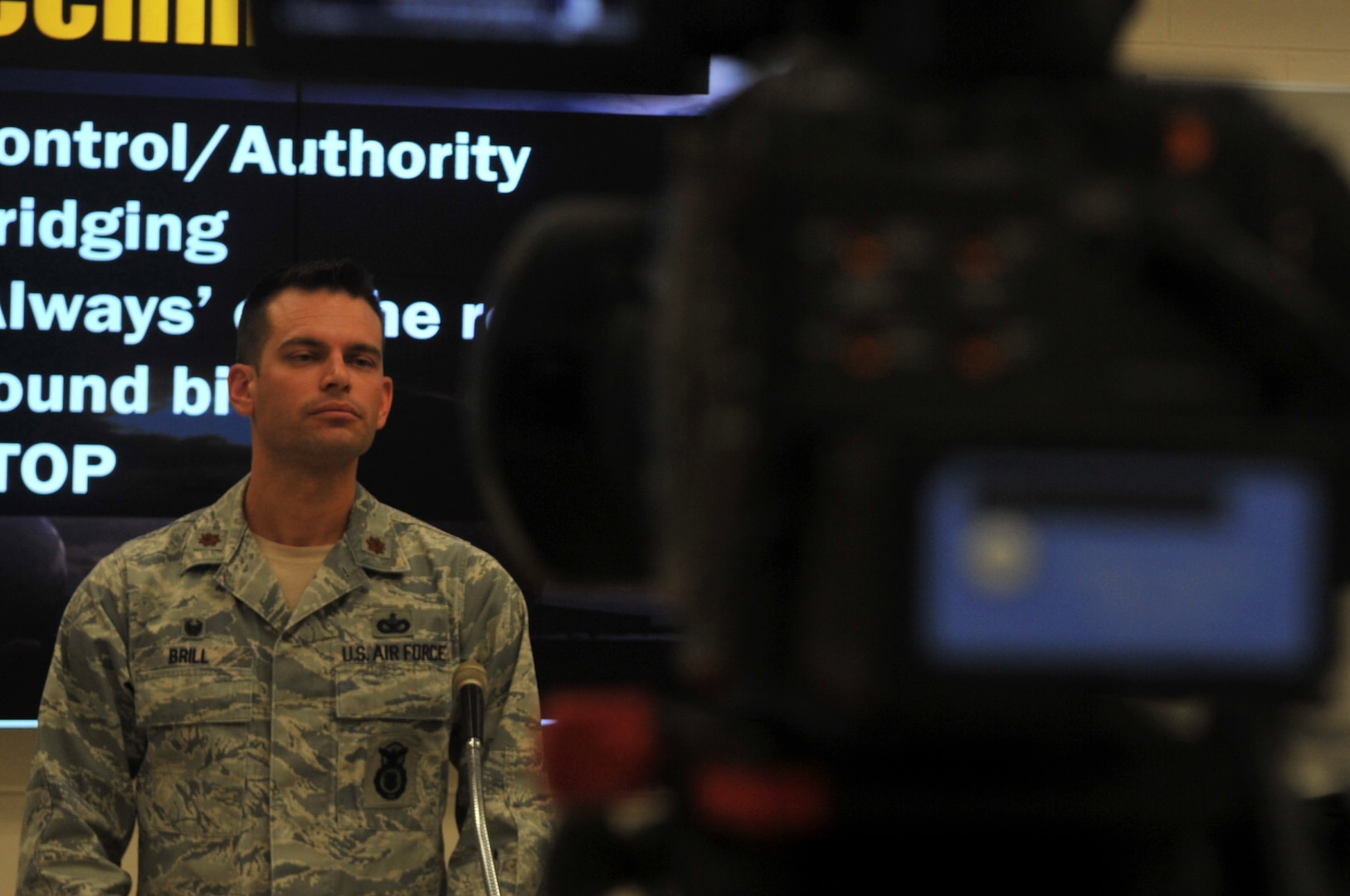 Maj. Matthew Brill, 460th Security Forces Squadron commander, volunteers to speak to the media in a simulated press conference during the Emergency Operations Center Director Course Aug. 4, 2016 at Buckley Air Force Base, Colo. The 460th Space Wing Public Affairs briefed students ont he importance of releasing accurate information regarding an incident to the public in a timely manner. (U.S. Air Force photo by Airman Holden S. Faul/ Released)