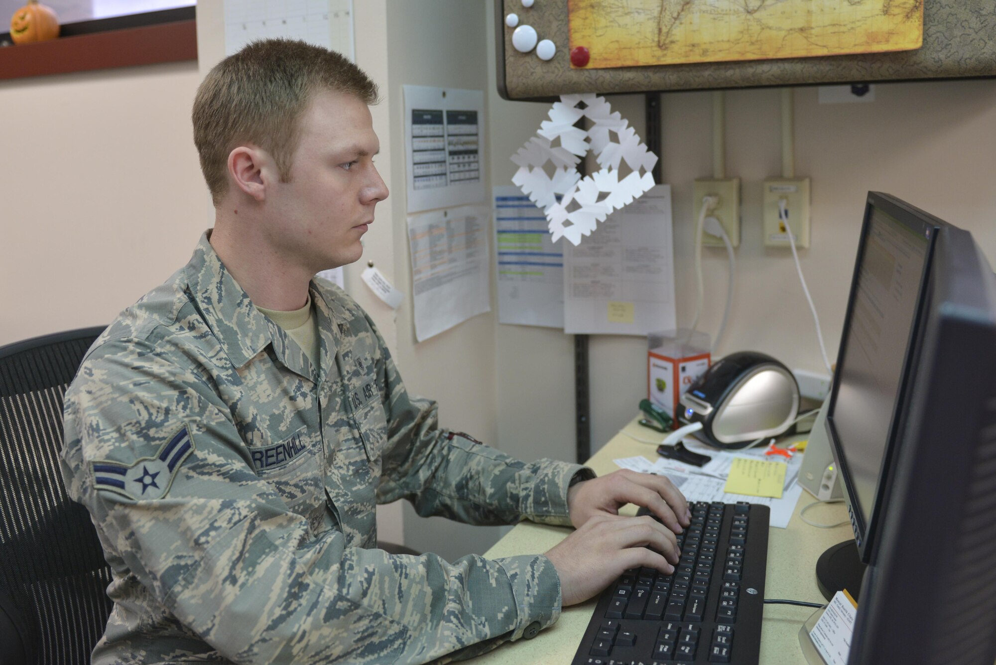 U.S. Air Force Airman 1st Class Terence Greenhill, a 354th Medical Group mental health technician, works at his computer Aug. 3, 2016, at Eielson Air Force Base, Alaska. Greenhill checks patients in for their appointments or walk-ins and explains the paperwork for them to fill out. (U.S. Air Force photo by Airman Isaac Johnson)